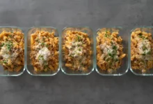 A top-down view of a creamy 30-minute high-protein pepper beef pasta in a skillet, featuring tender beef strips, colorful bell peppers, and a rich sauce, garnished with fresh herbs