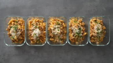 A top-down view of a creamy 30-minute high-protein pepper beef pasta in a skillet, featuring tender beef strips, colorful bell peppers, and a rich sauce, garnished with fresh herbs
