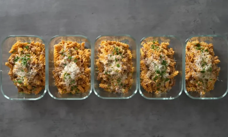 A top-down view of a creamy 30-minute high-protein pepper beef pasta in a skillet, featuring tender beef strips, colorful bell peppers, and a rich sauce, garnished with fresh herbs